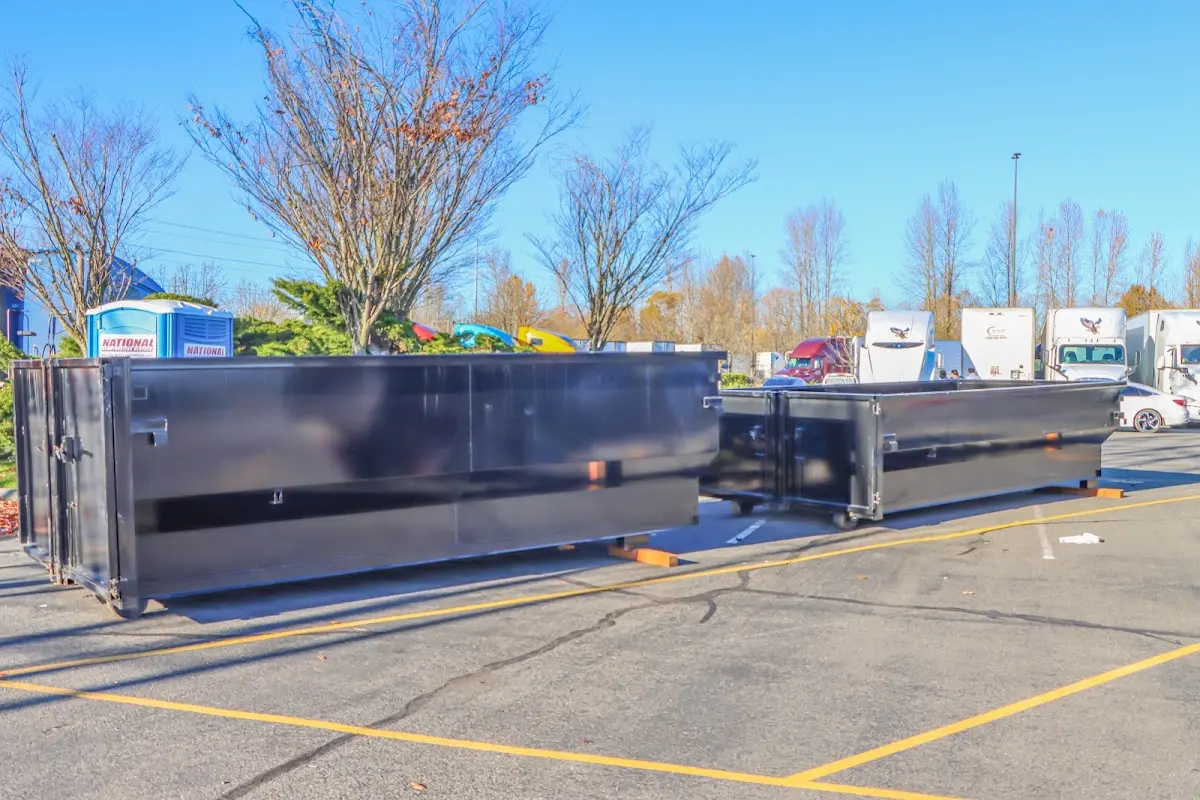 Professional dumpster rental service with roll-off container on residential driveway in Vincennes